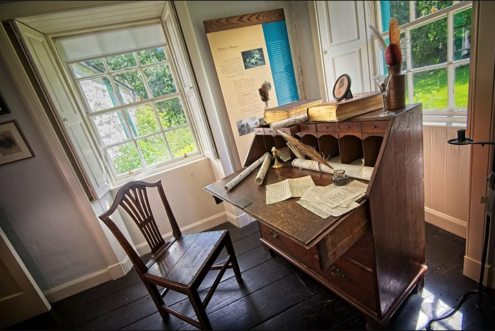 A writing desk in the spence staged to appear as it would when Robert Burns was there.